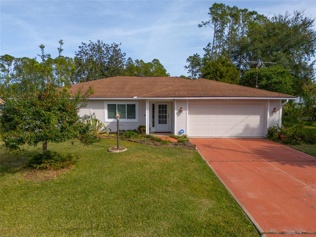 a front view of a house with yard and green space