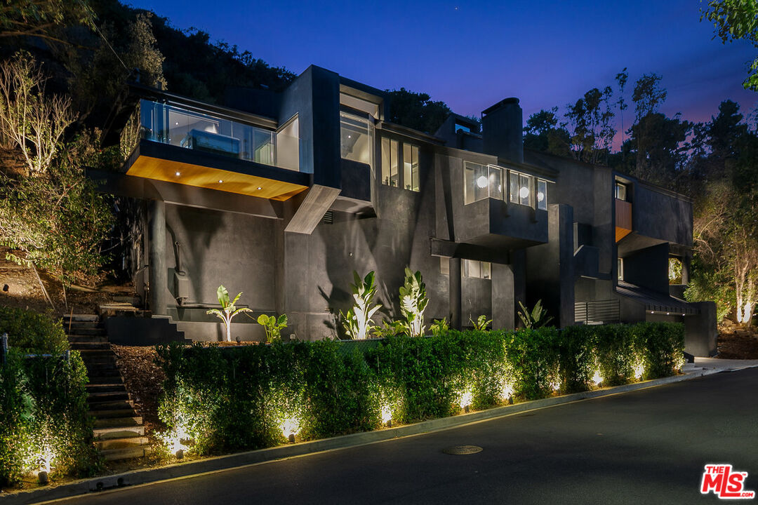 front view of house with potted plants