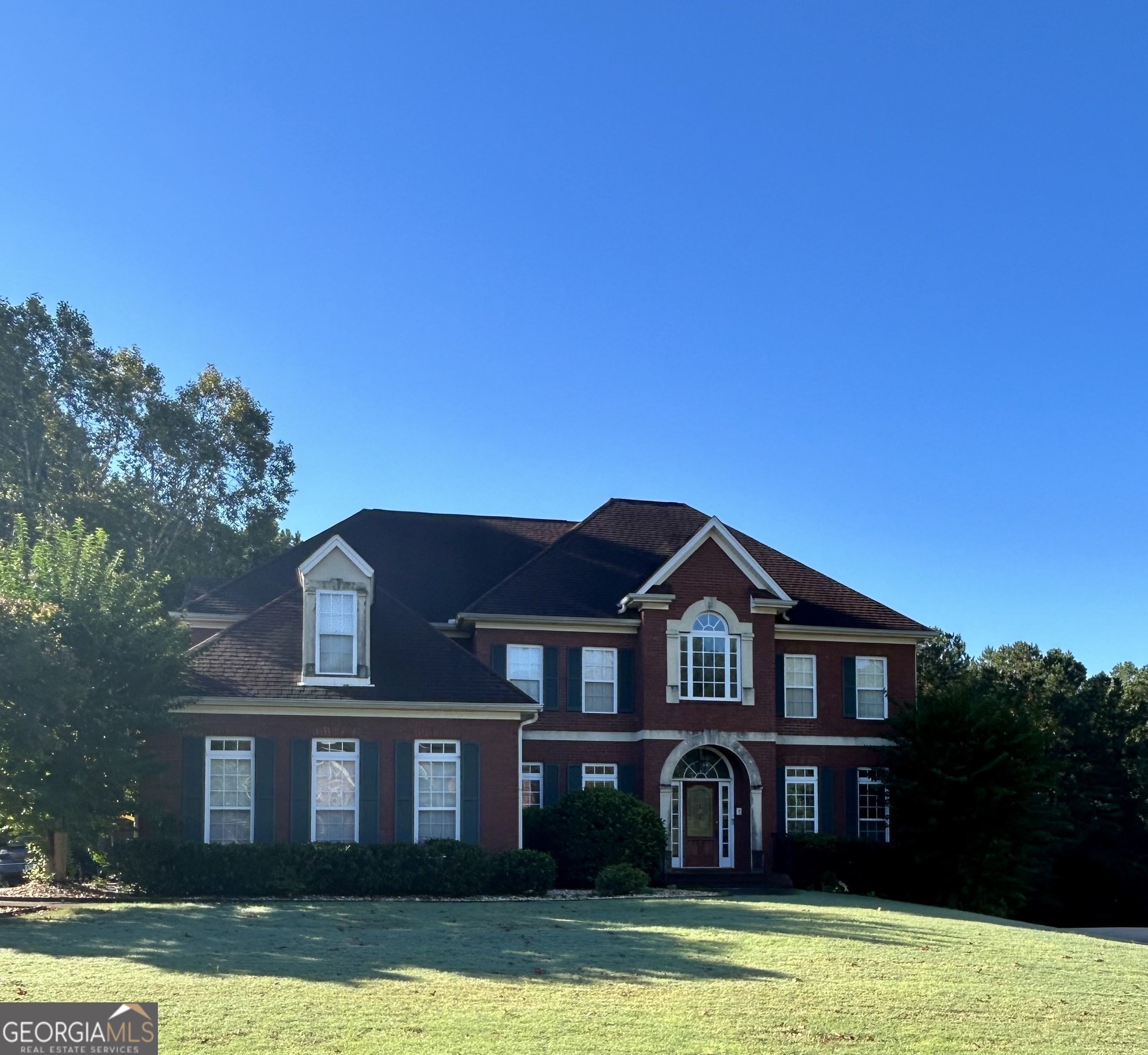 a front view of a house with garden