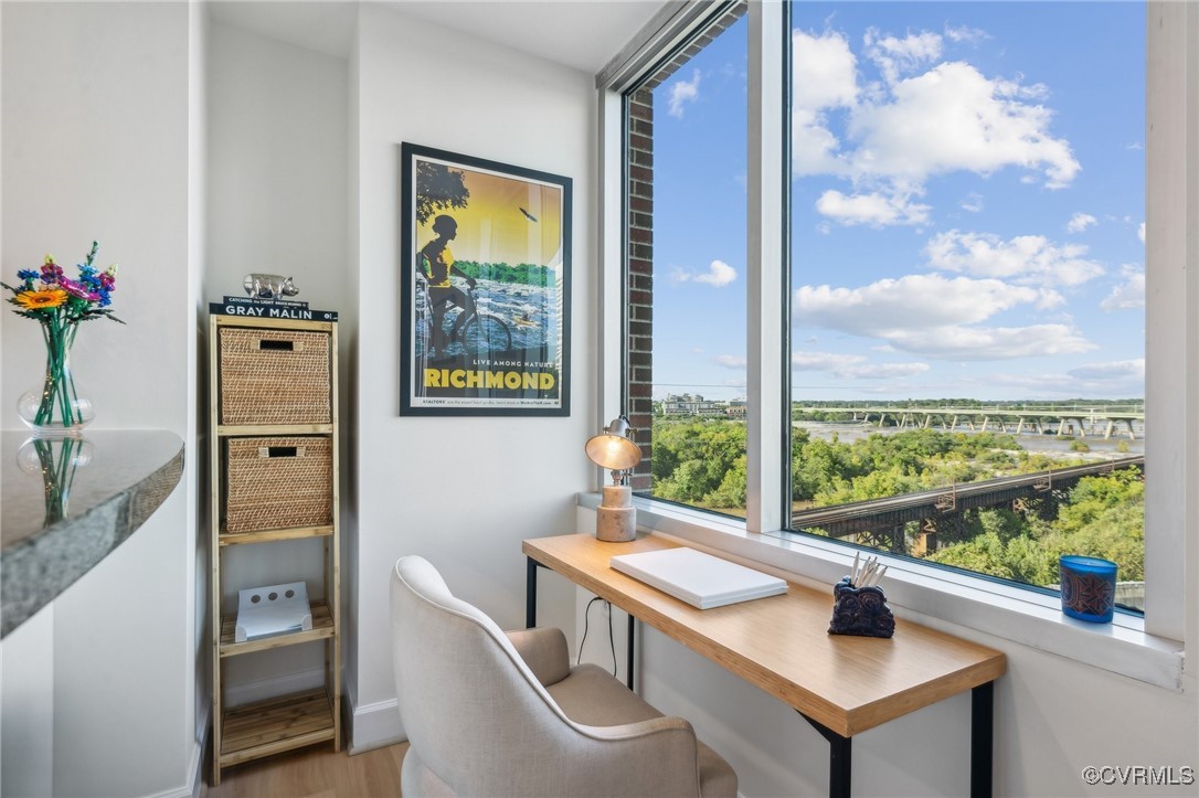 a view of a workspace with furniture and a window