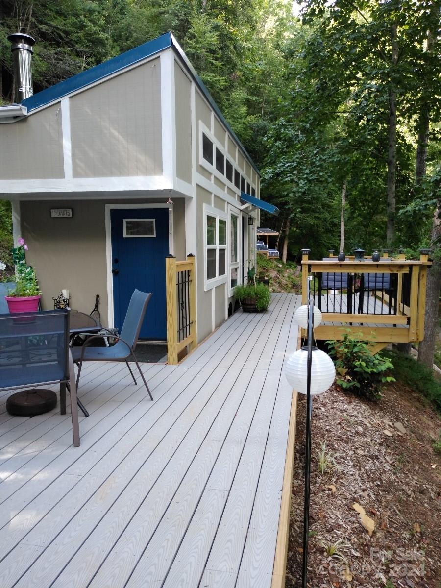 a view of house with backyard outdoor seating and hardwood