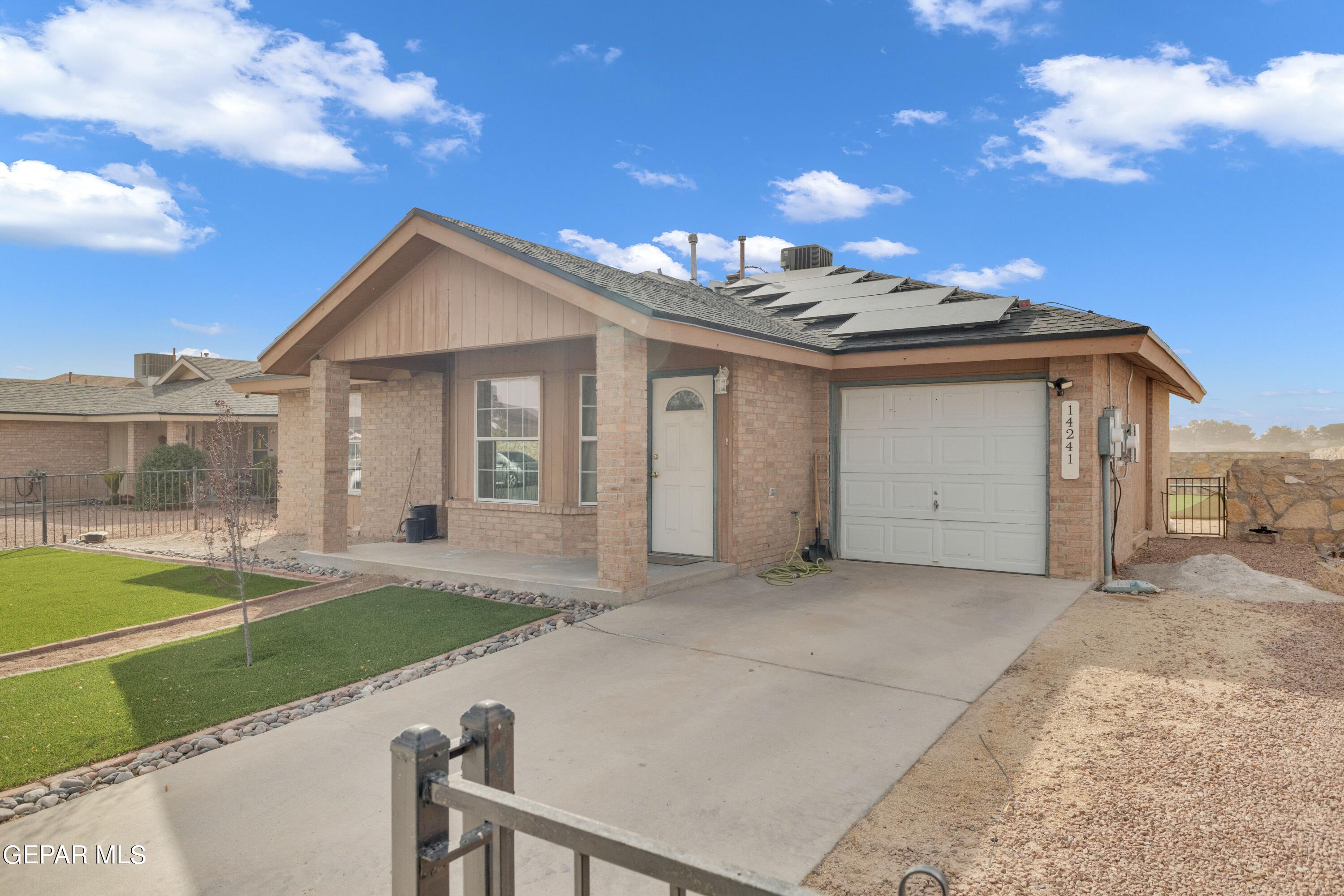 a view of a house with a yard and garage