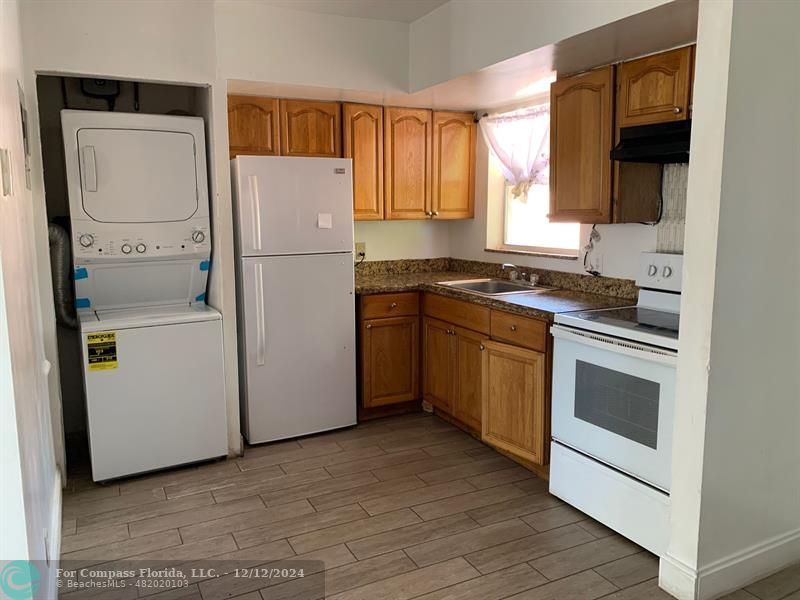 a white refrigerator freezer sitting inside of a kitchen