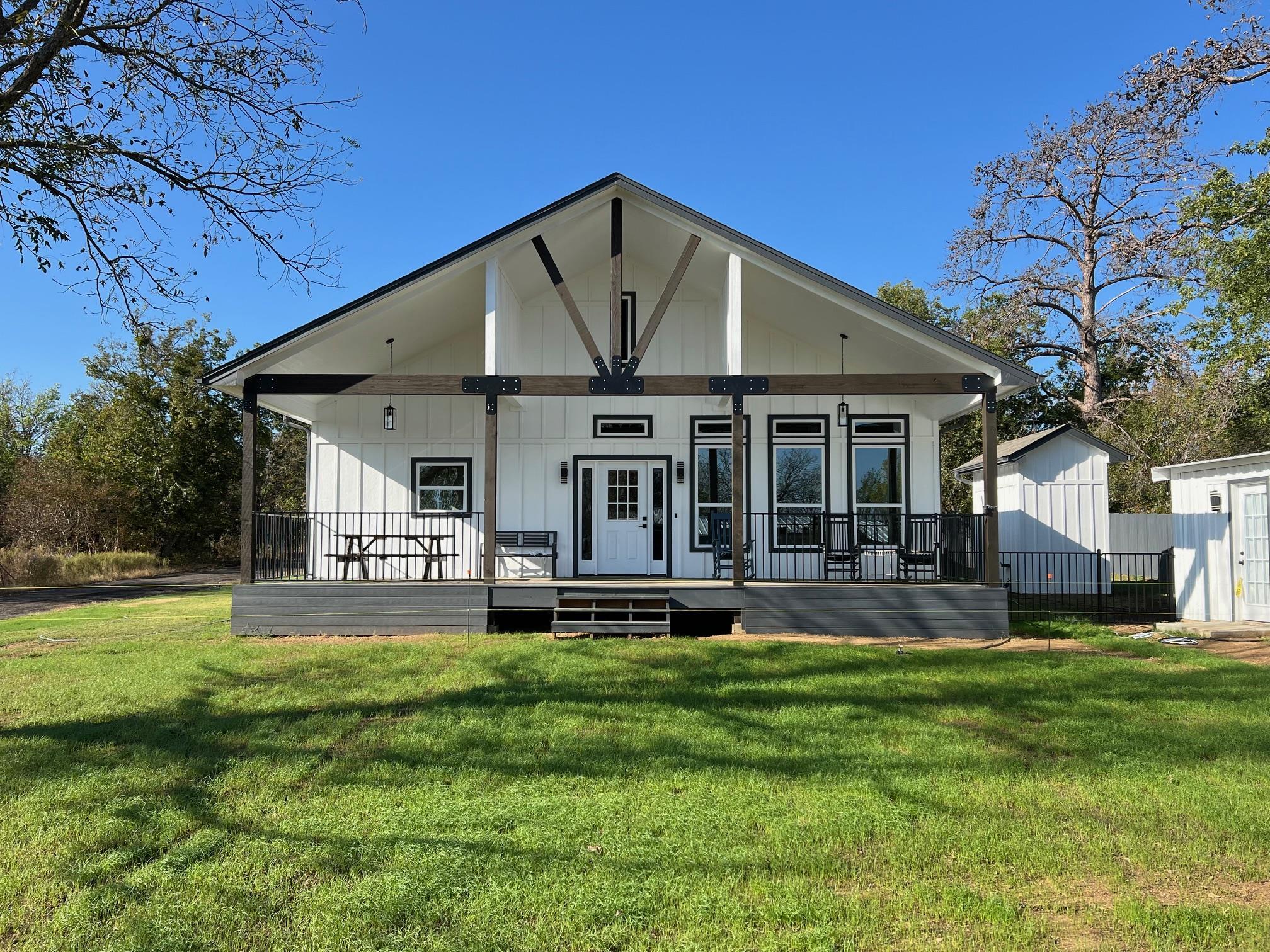 a front view of a house with a yard porch and outdoor seating