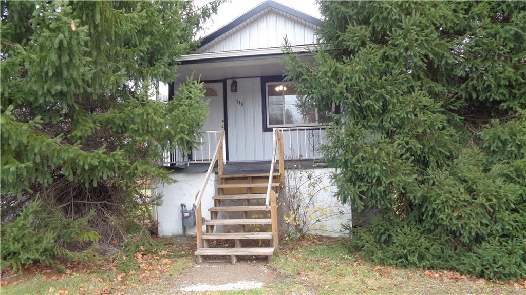 a view of a house with a yard and plants