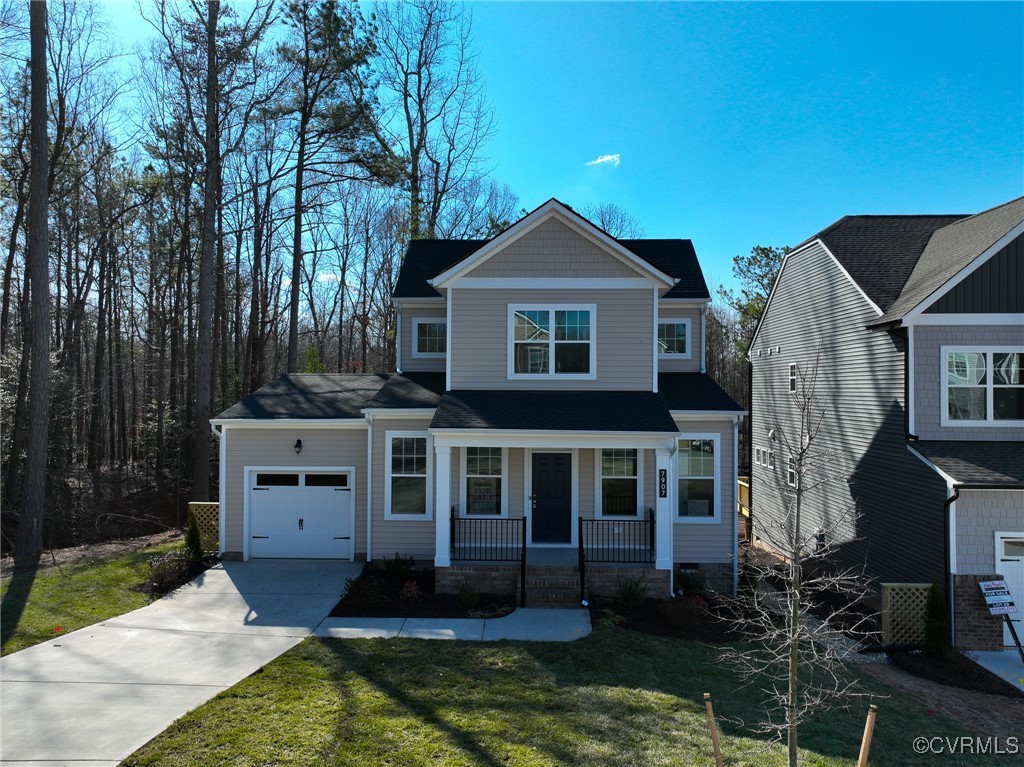 View of front of home with a garage, covered porch