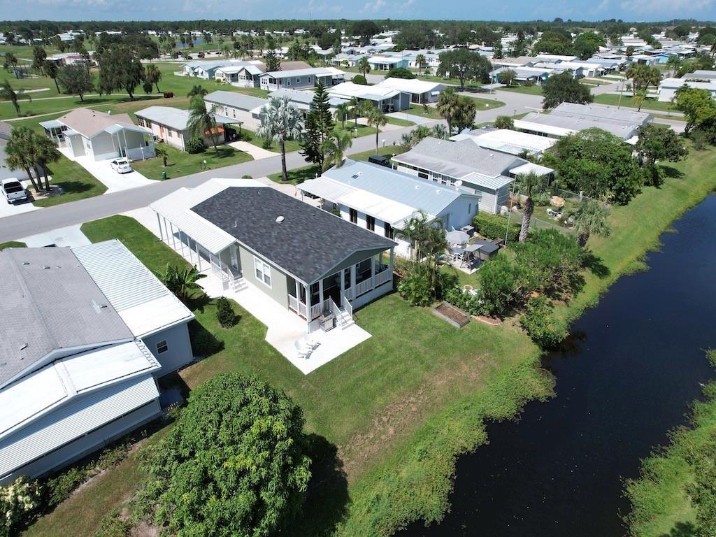 an aerial view of multiple houses with yard