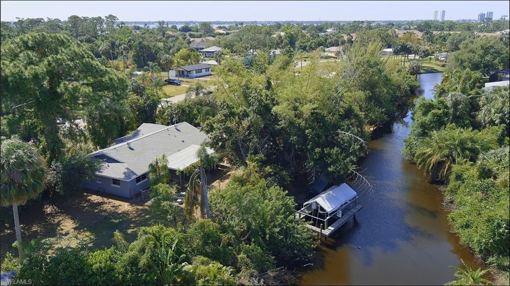 an aerial view of a house with outdoor space and a lake view