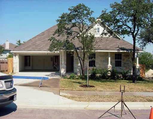 a view of a house with backyard sitting area and tree