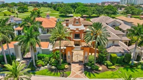 an aerial view of residential houses with outdoor space and swimming pool