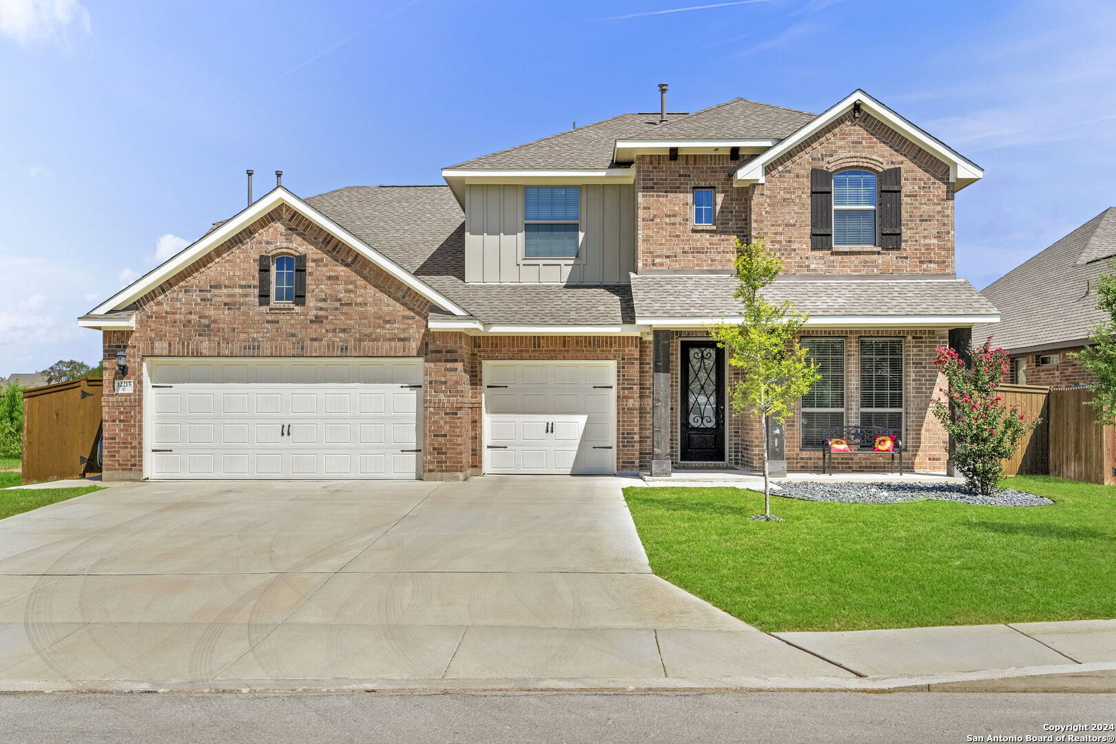 a front view of a house with a yard and garage