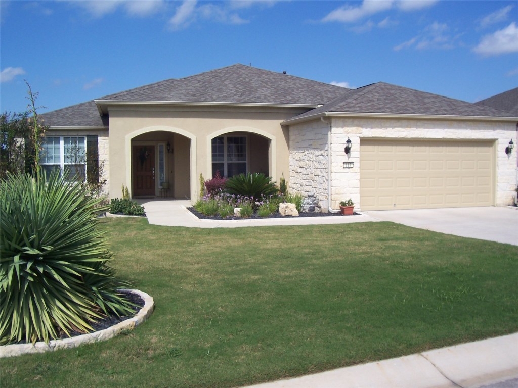 a front view of a house with a yard