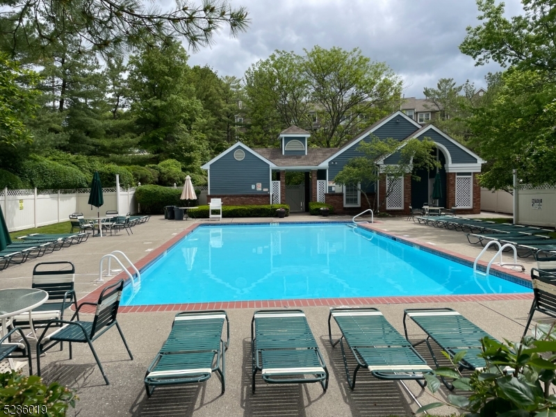 a view of a house with swimming pool and sitting area