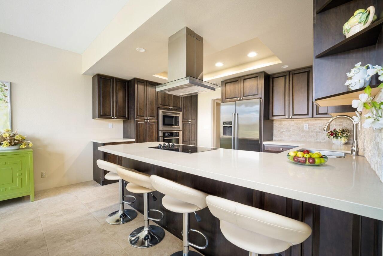 a kitchen with a table chairs and a refrigerator