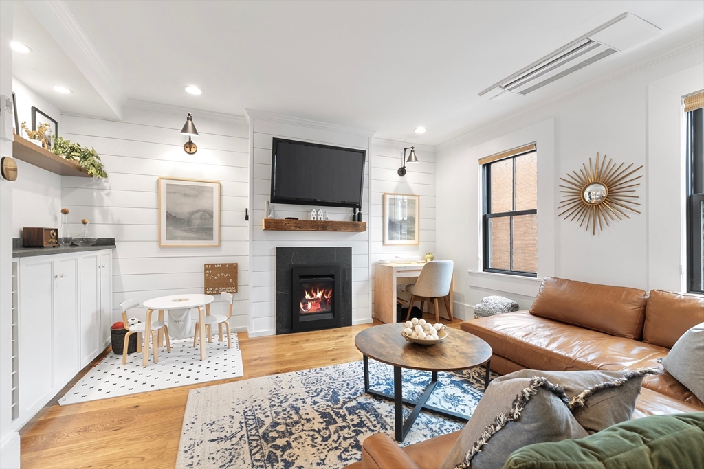 a living room with furniture a rug and a fireplace