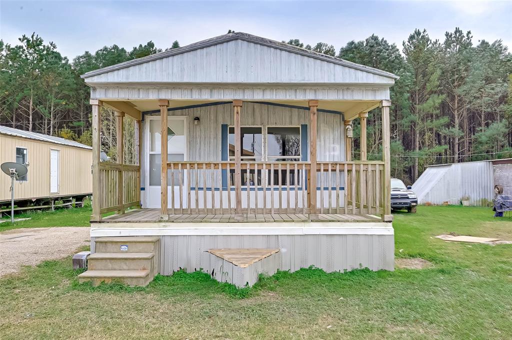 a view of a house with a yard and deck