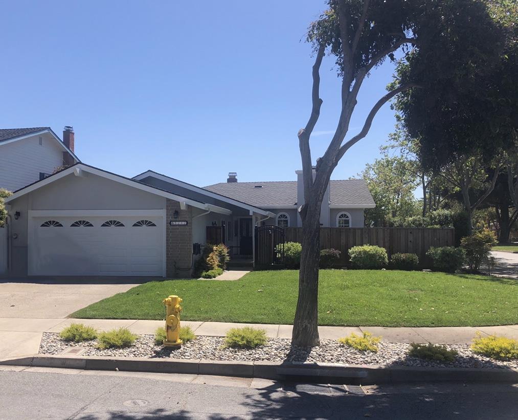 a front view of house with yard and green space