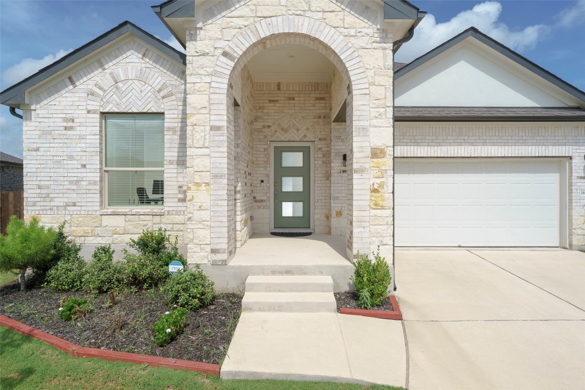 a front view of a house with garage