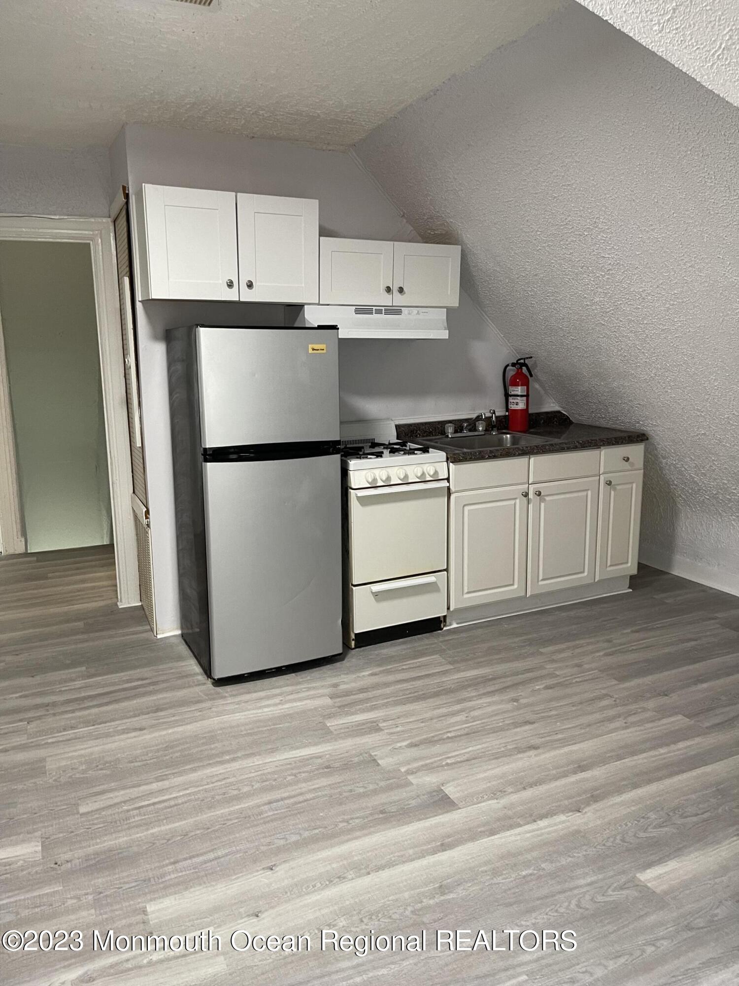 a kitchen with stainless steel appliances a refrigerator sink and cabinets