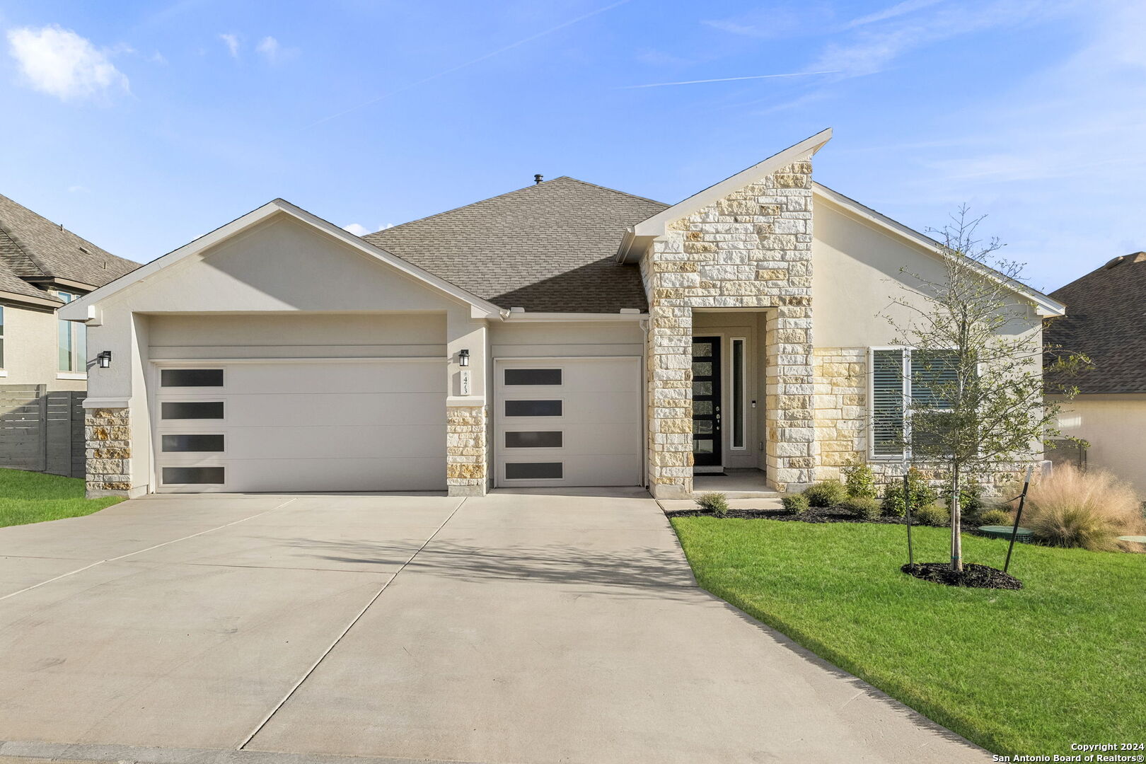 a front view of a house with a yard and garage