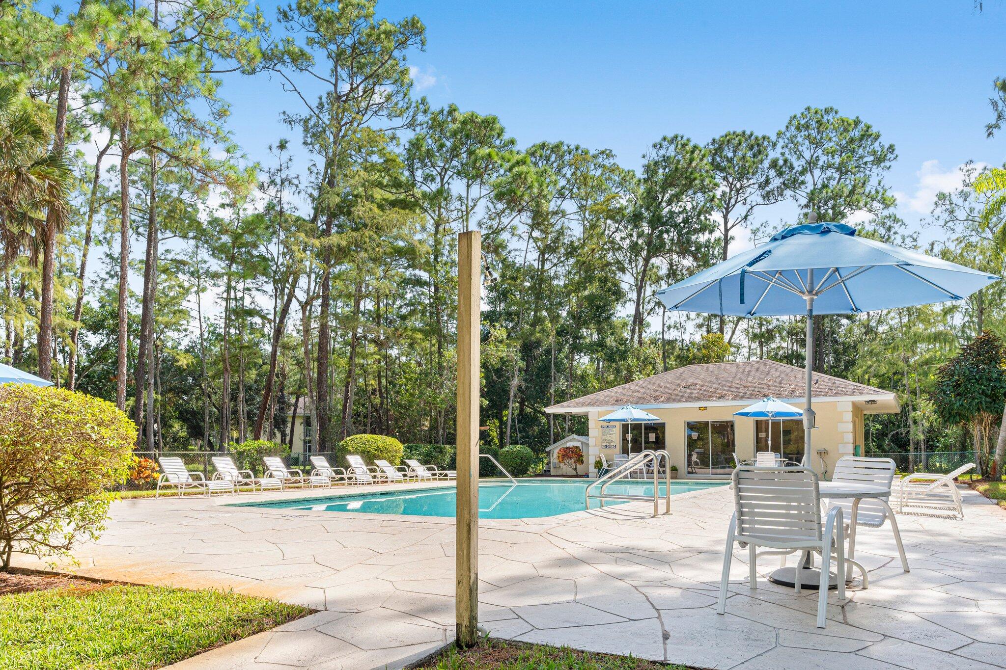 a patio table and chairs under an umbrella