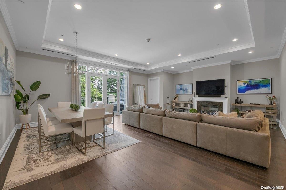 a living room with furniture wooden floor and a flat screen tv