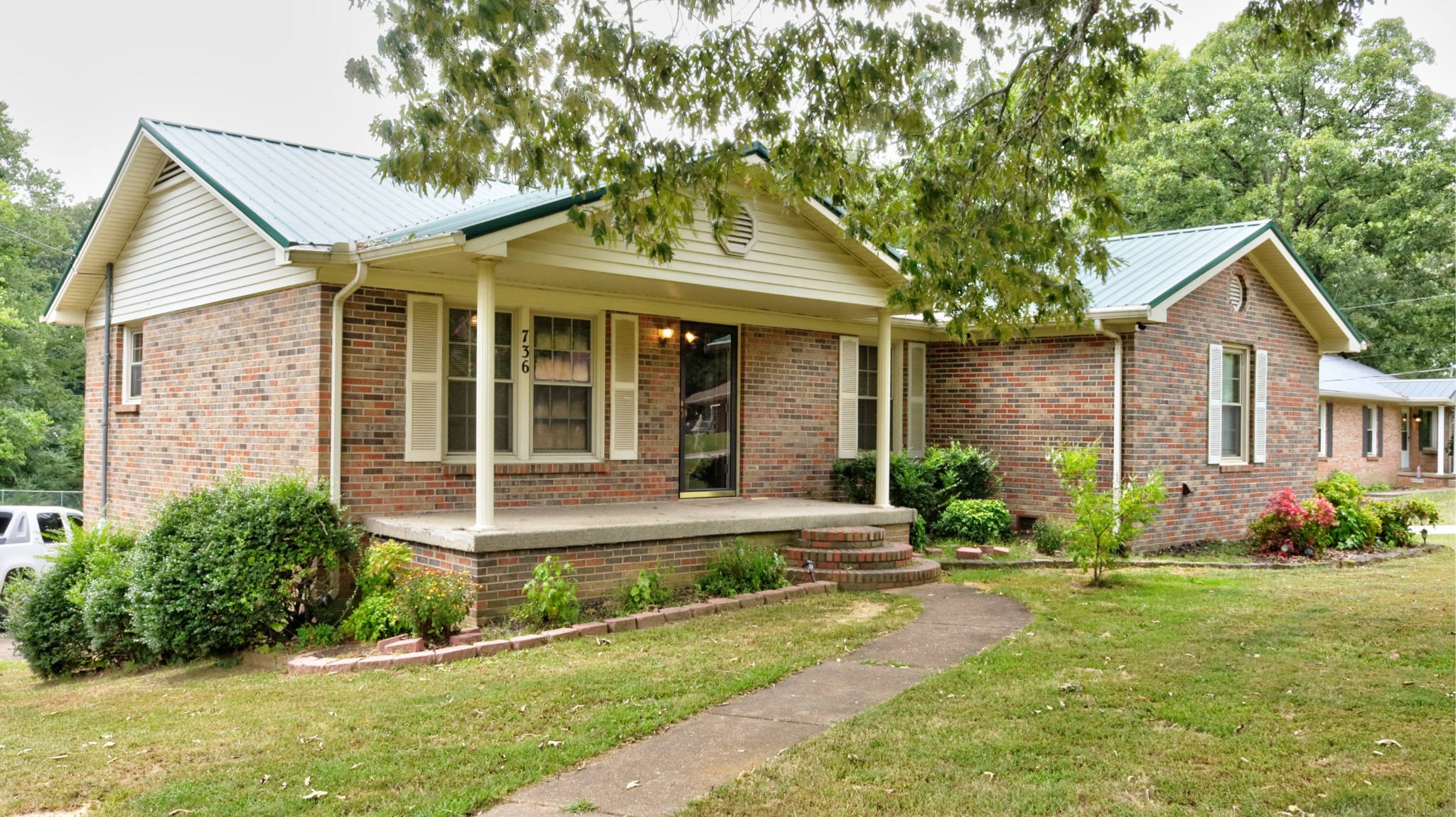 a front view of a house with garden