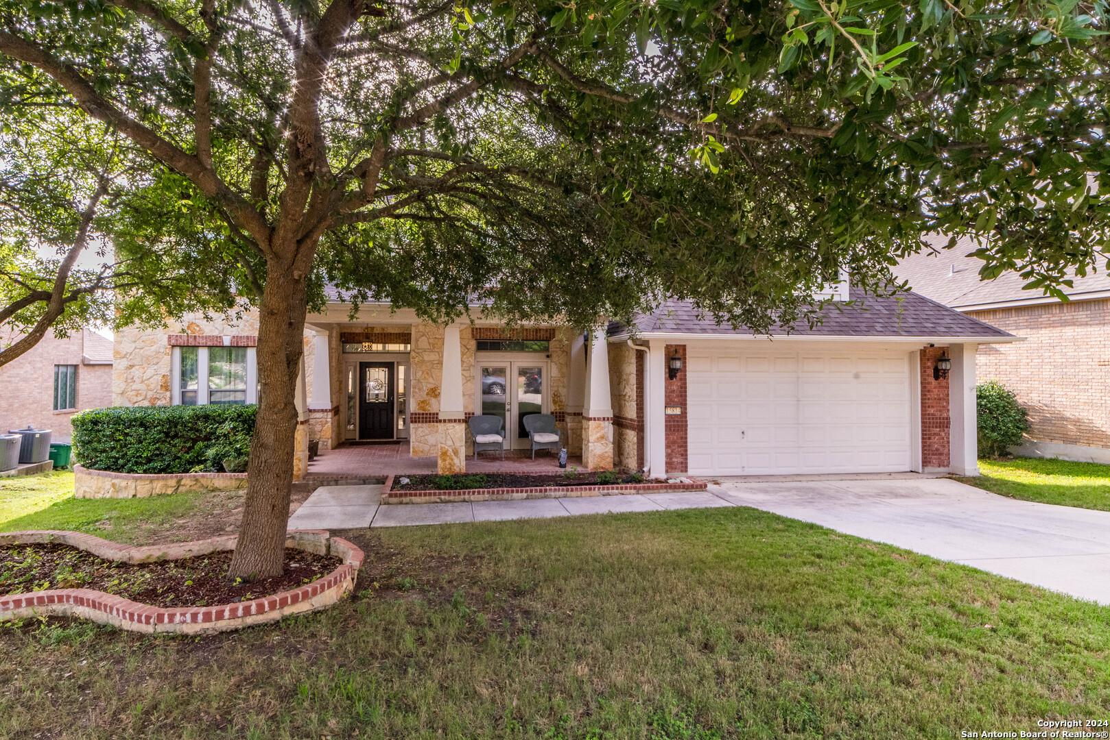 a front view of house with yard and green space