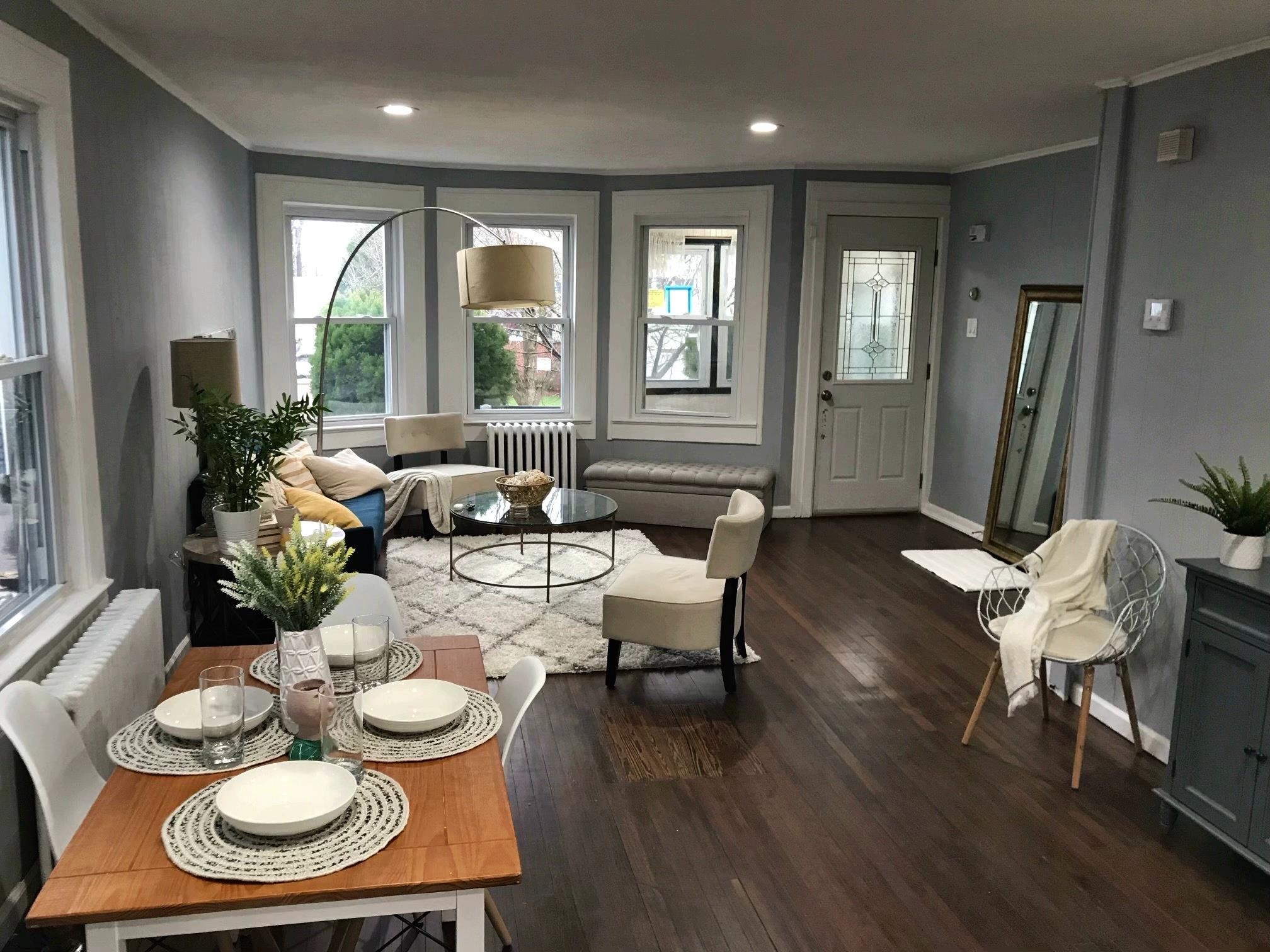 a living room with furniture and a dining room