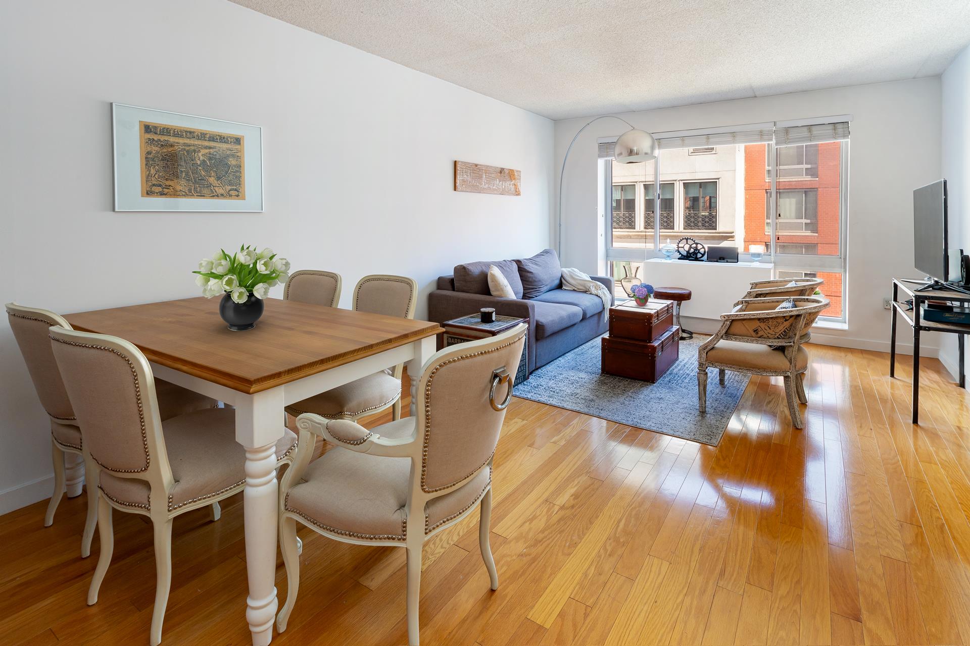 a view of a dining room with furniture window and wooden floor