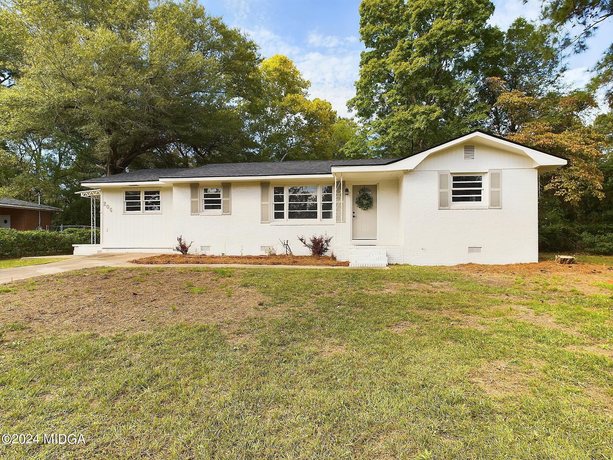 a front view of house with yard and trees