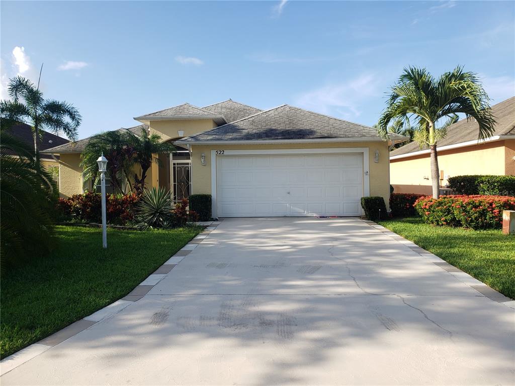 a front view of house with yard and green space