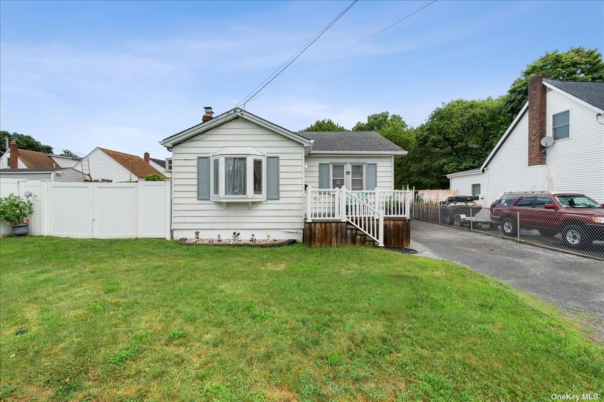 a front view of a house with a garden and yard