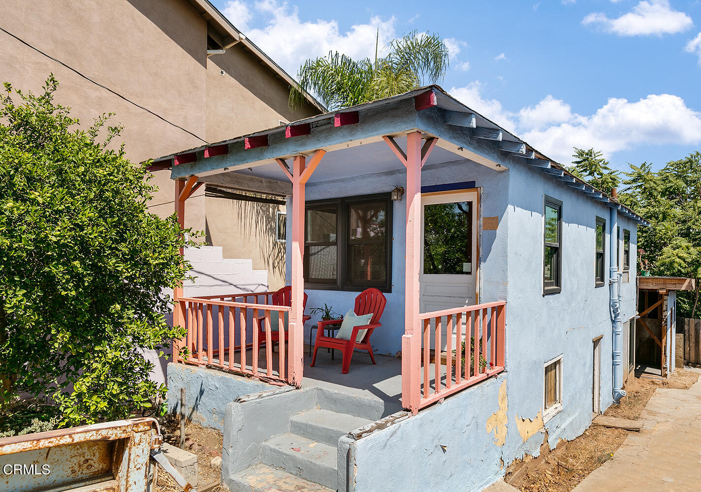 a view of a house with a balcony and wooden floor