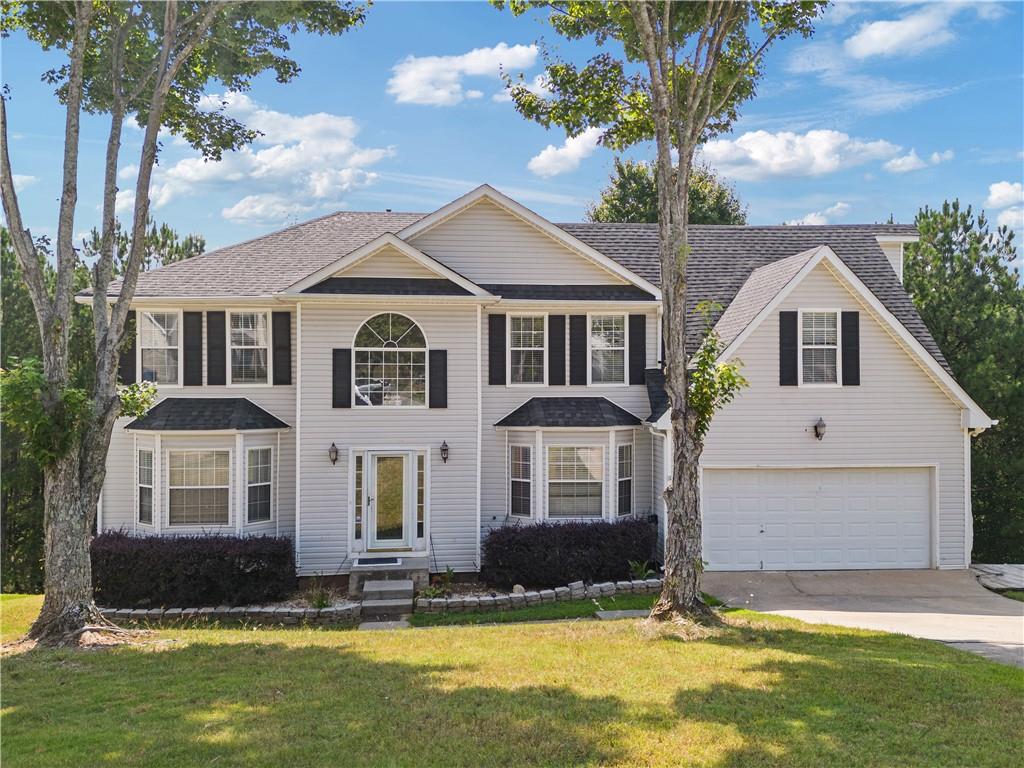 a front view of a house with a yard