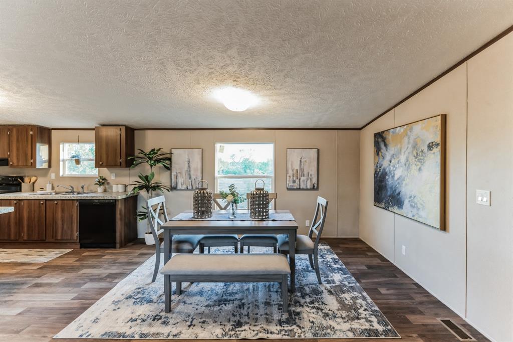 a room with furniture and view of kitchen