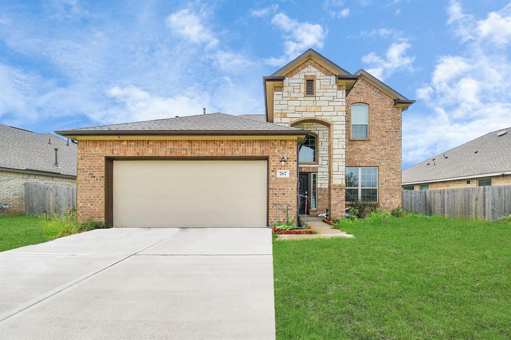 a front view of a house with a yard and garage