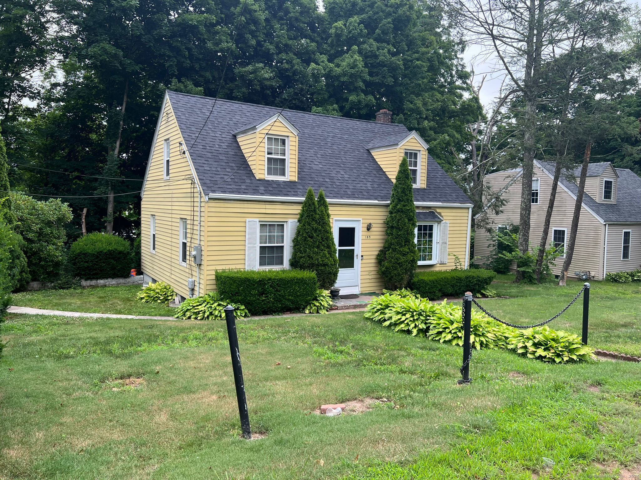 a front view of a house with a yard and table and chairs