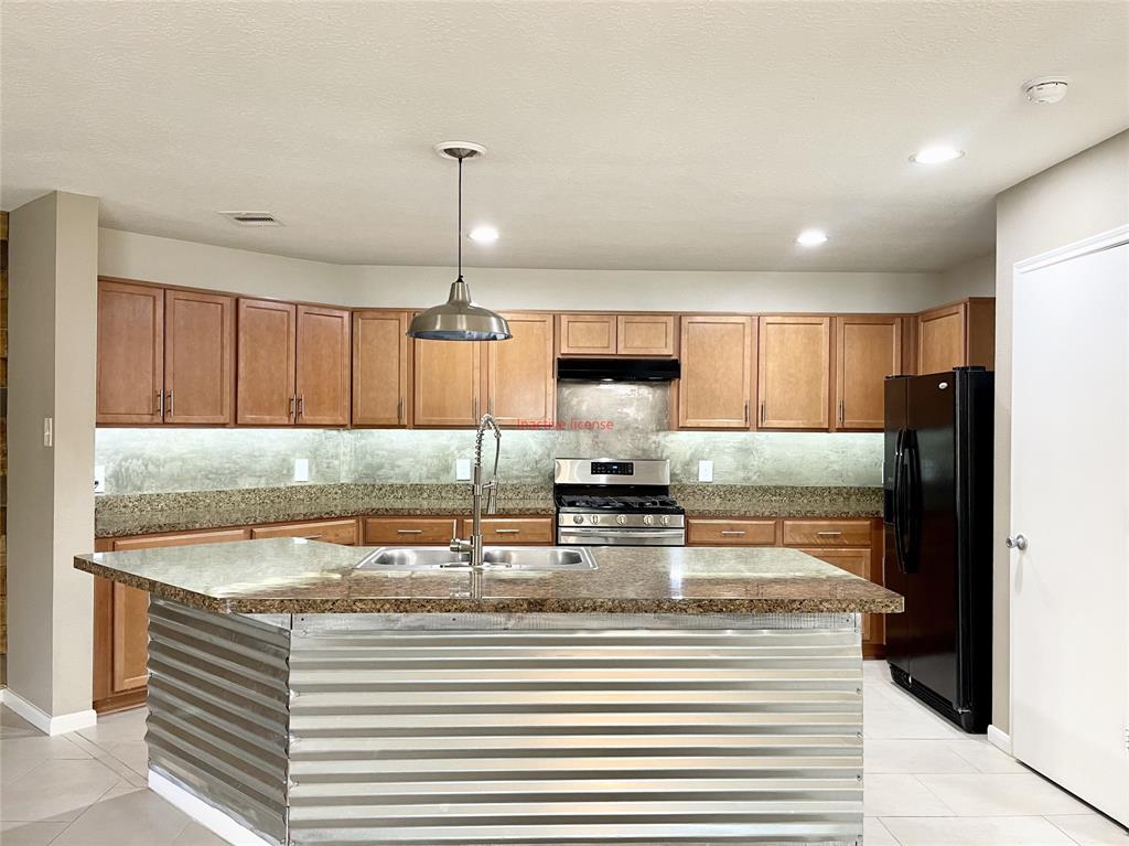 a kitchen with stainless steel appliances granite countertop a sink window and cabinets