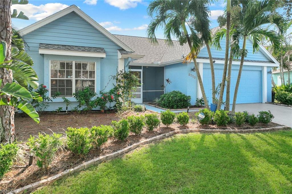 View of front of home featuring a garage and a front lawn