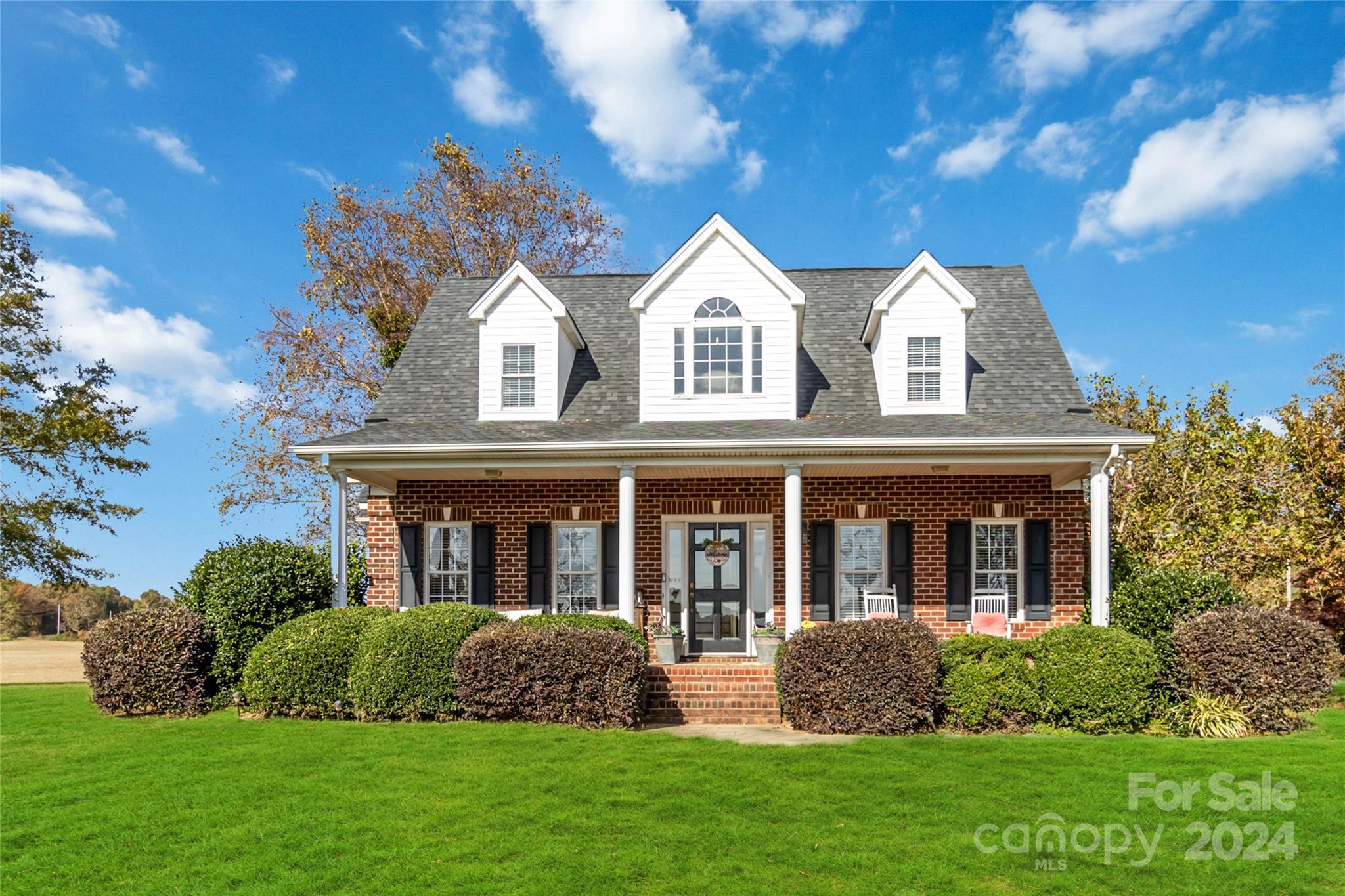 a front view of a house with a garden