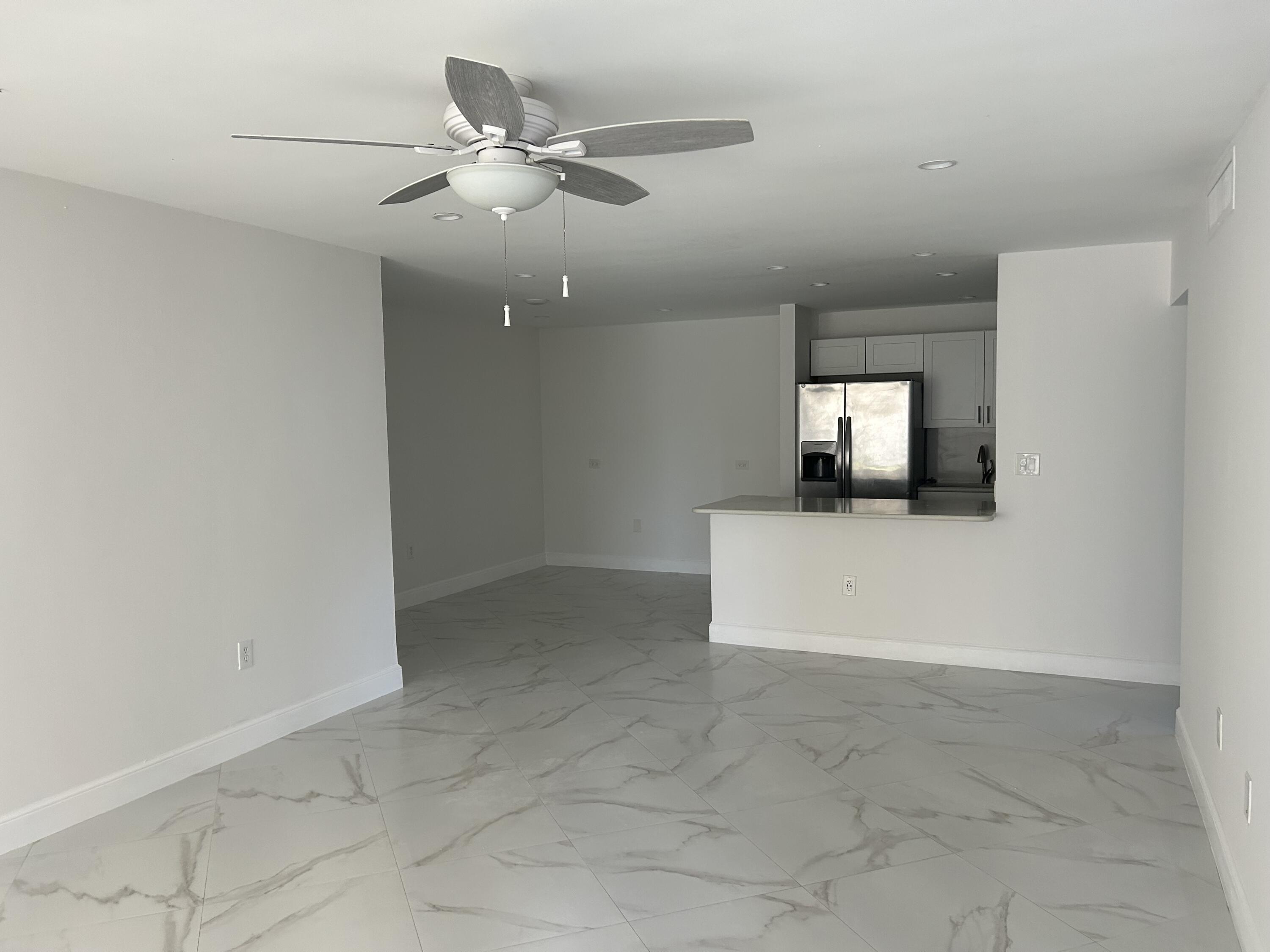 an empty room with projector and fan