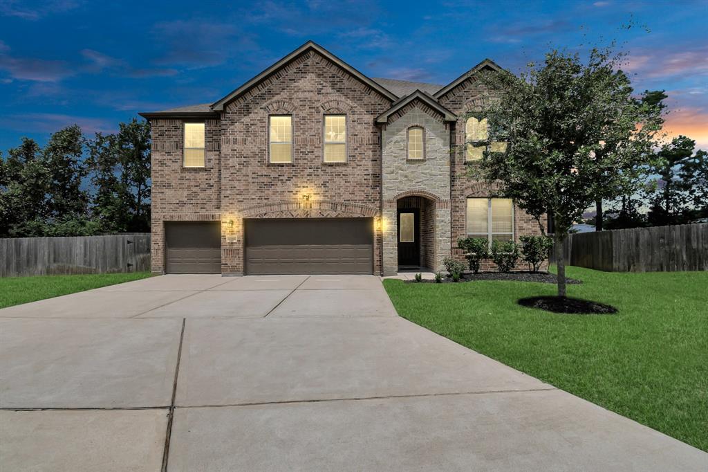 a front view of a house with a yard and garage