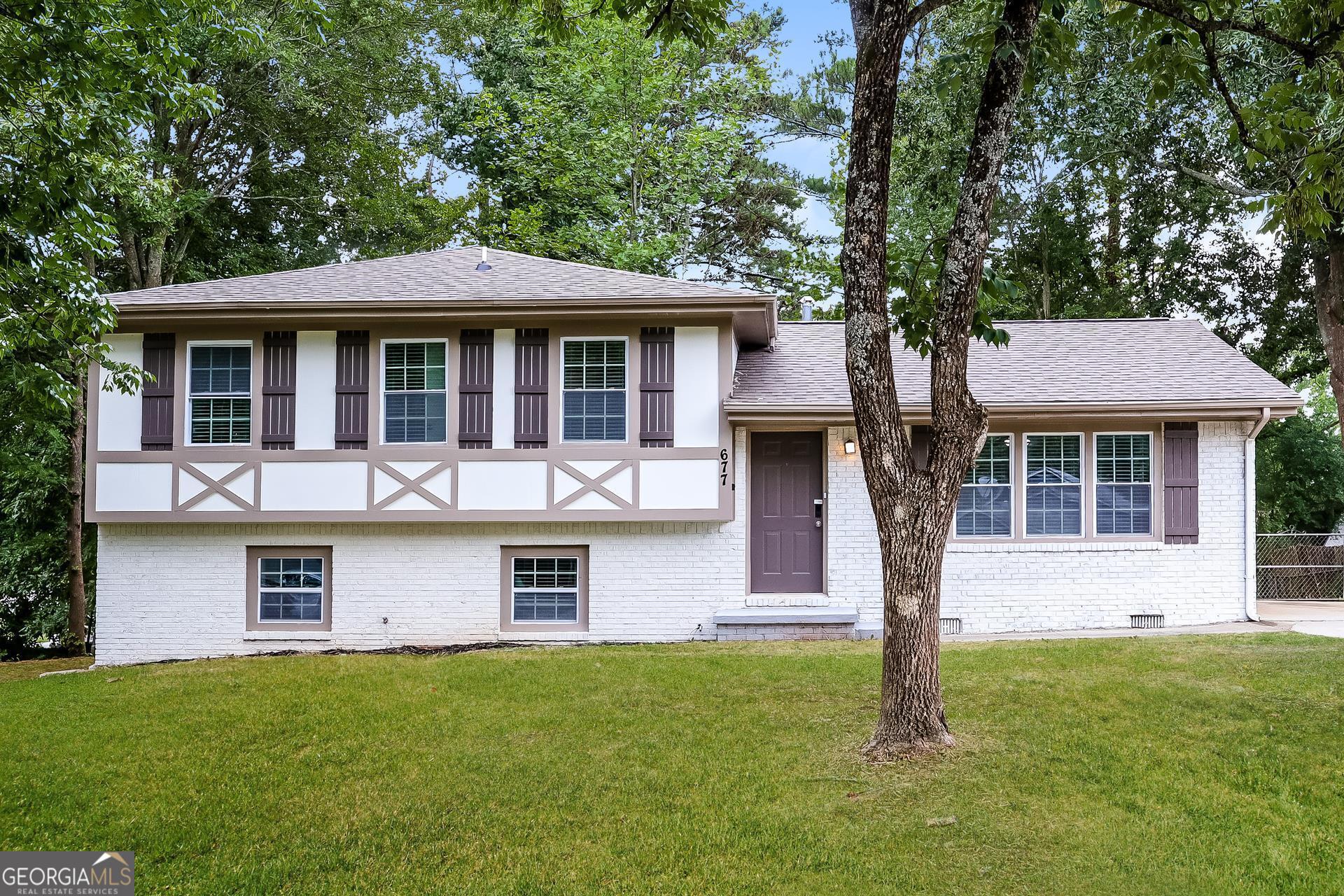 a front view of a house with a garden