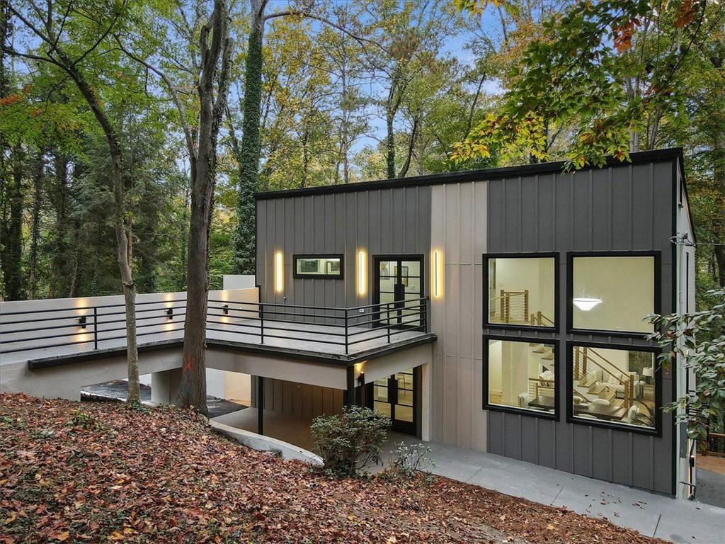 a view of a house with a window and wooden fence