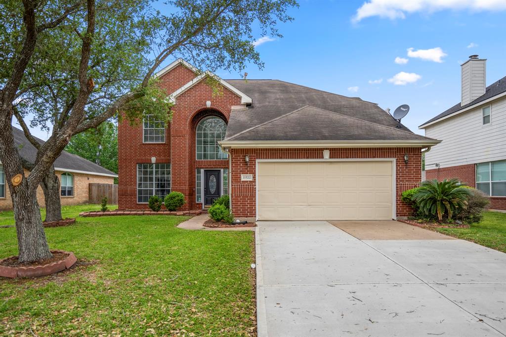 a front view of a house with a yard and garage