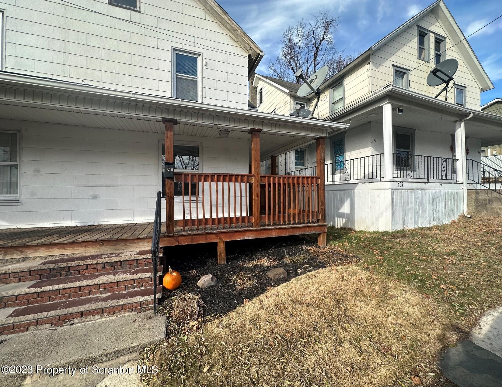 a view of a house with a wooden deck