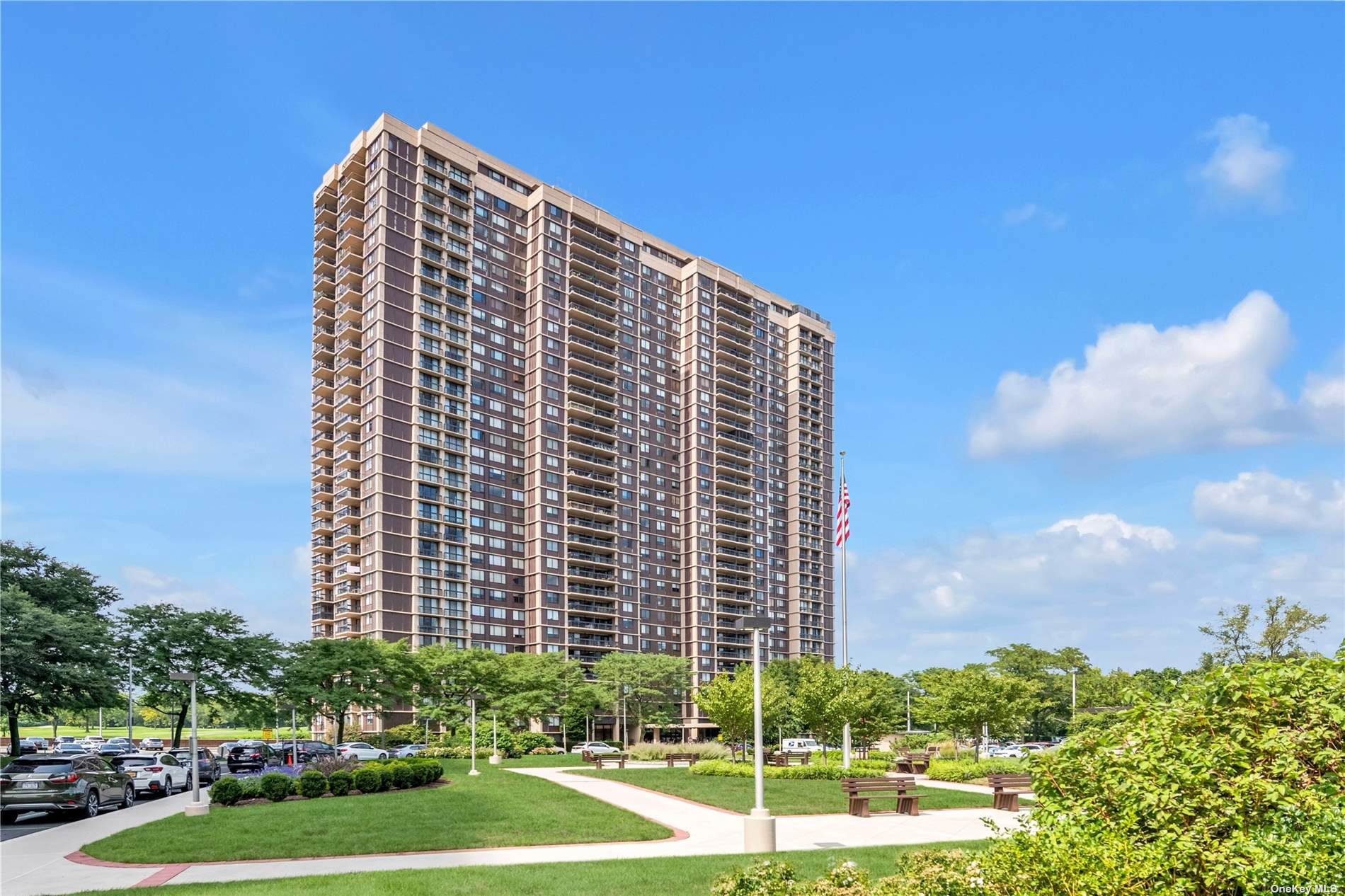 a view of a tall building with a yard