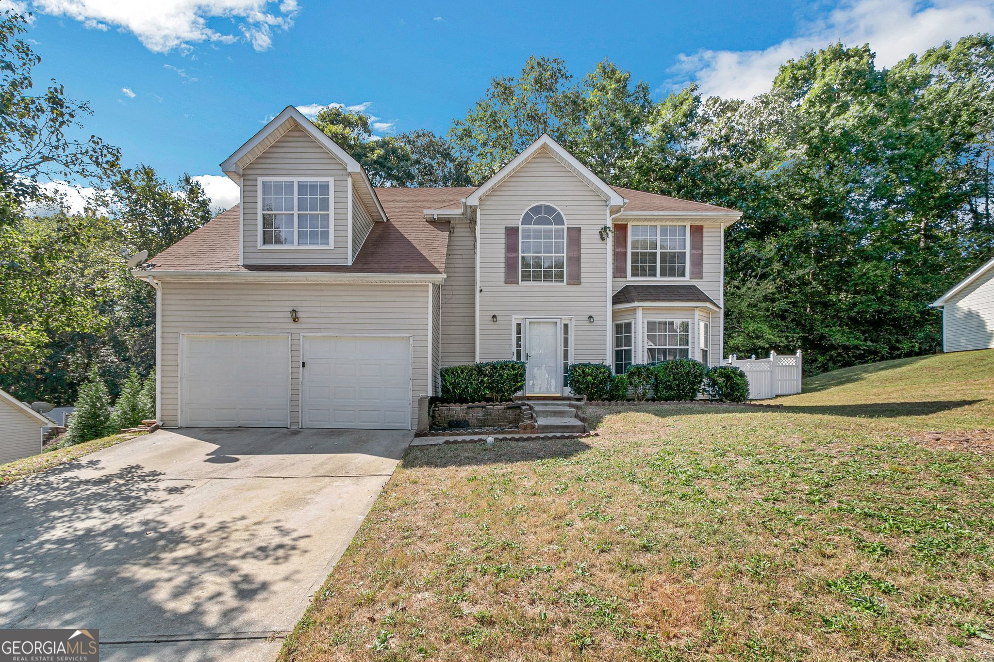 a front view of a house with a yard