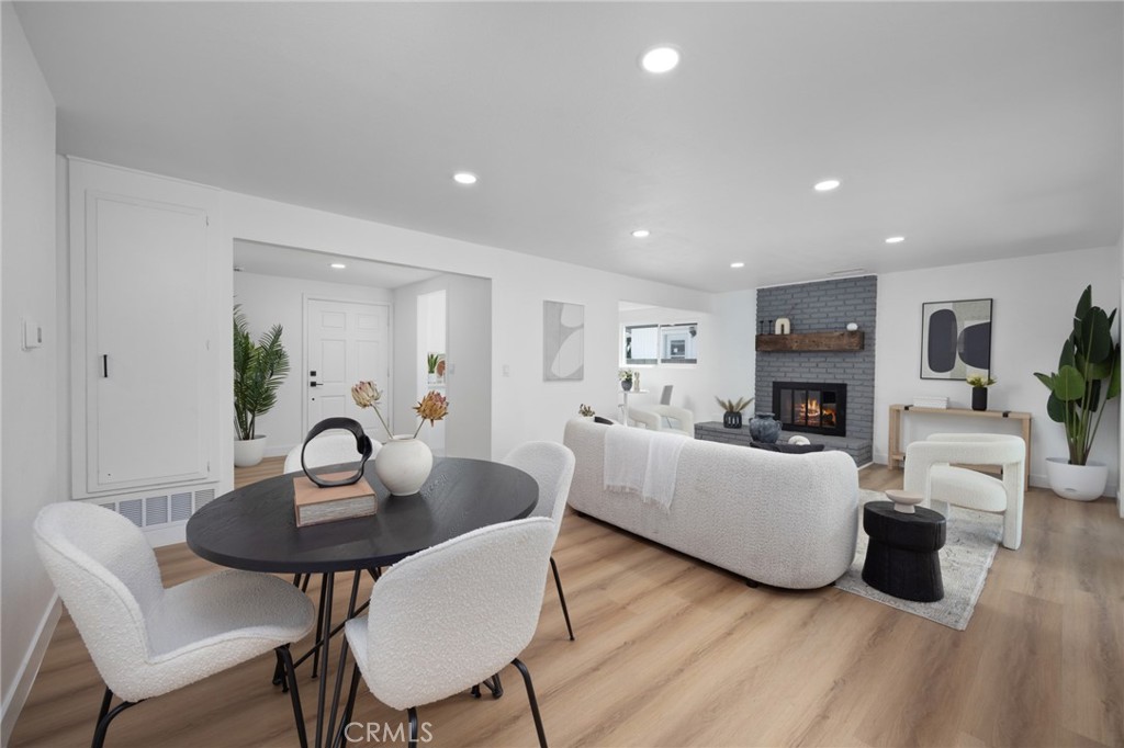 a living room with furniture a fireplace and a table